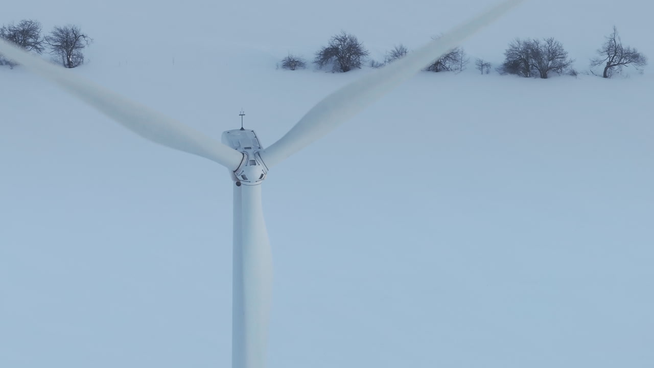 Winter wind turbine in snowy Shelburne, Ontario, serene energy scene