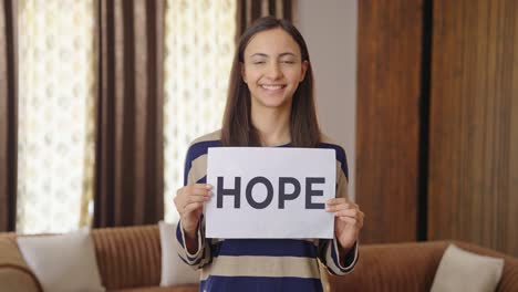 happy indian woman holding hope banner