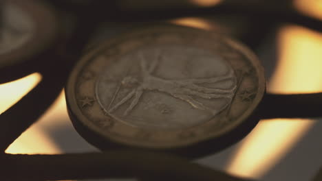 close-up of a euro coin with vitruvian man design