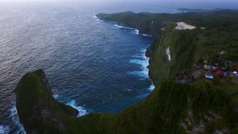 sea and rocks at kelingking beach, nusa penida, bali, indonesia - aerial drone shot