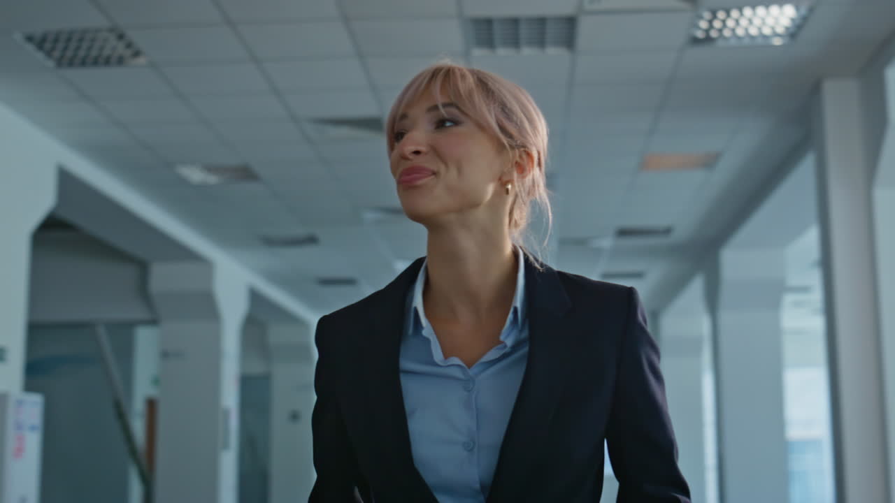 Satisfied businesswoman strolling hall looking around closeup. Boss waiting