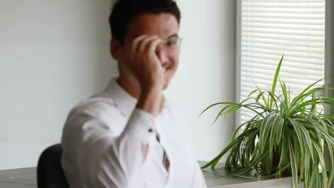 focusing on a man getting off his glasses