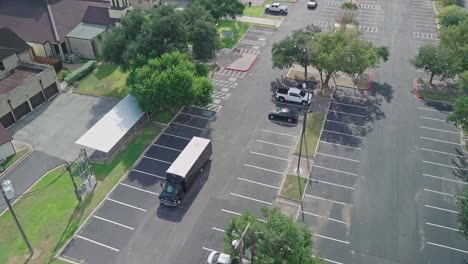 AERIAL---A-truck-driving-down-a-parking-lot,-McAllen,-Texas,-United-States,-reverse