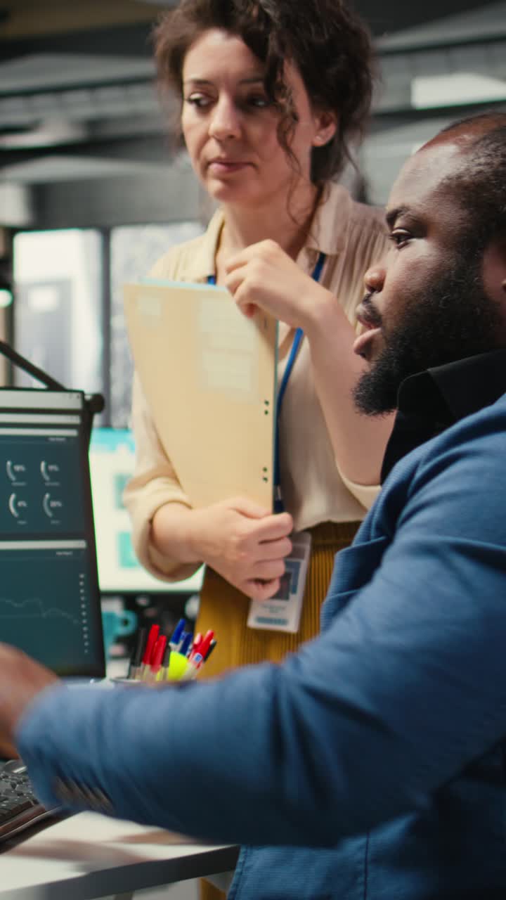 Vertical Video Colleagues engaging in discussion and consulting around performance metrics