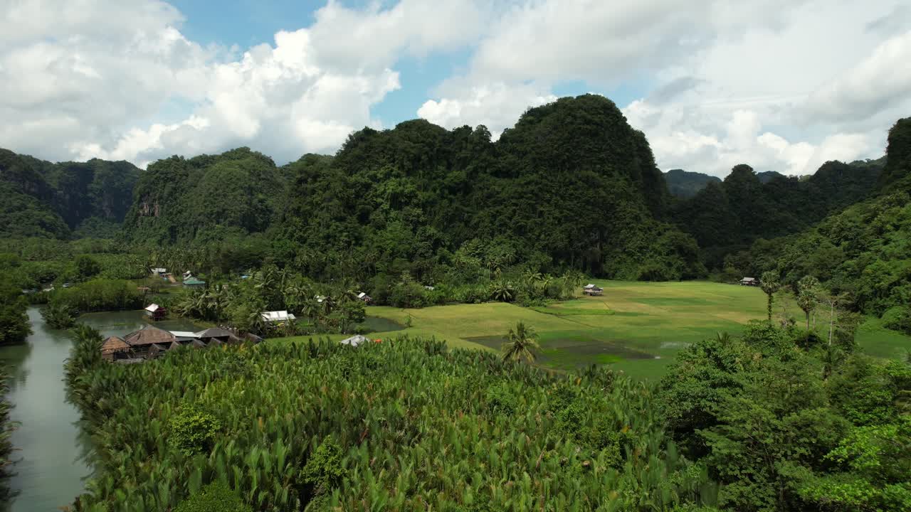 배경에 석회암 산이 있고 맹그로브 숲으로 둘러싸인 강이 있는 라망 라망 술라웨시의 계곡의 공중 전망