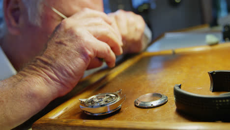 close-up of horologist repairing a watch