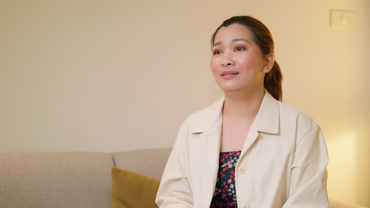 Young adult woman explaining and interview video online communication with casual clothing and speaking in room