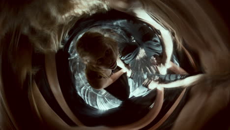 Amazed Woman Sitting amidst Swirling Distorted Reflections and Flickering Light