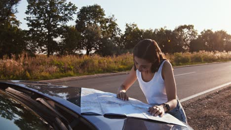 woman checking map by the side of road