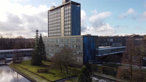 Aerial-view-Pilkington's-glass-head-office-building,-blue-high-rise-with-shared-office-space-and-gardens