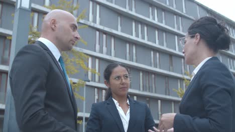 business team standing at office building and discussing project together