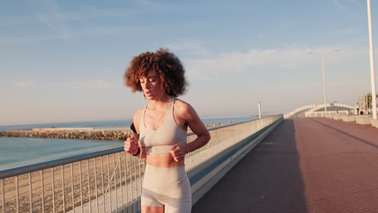 Woman Jogging on Beach at Sunrise