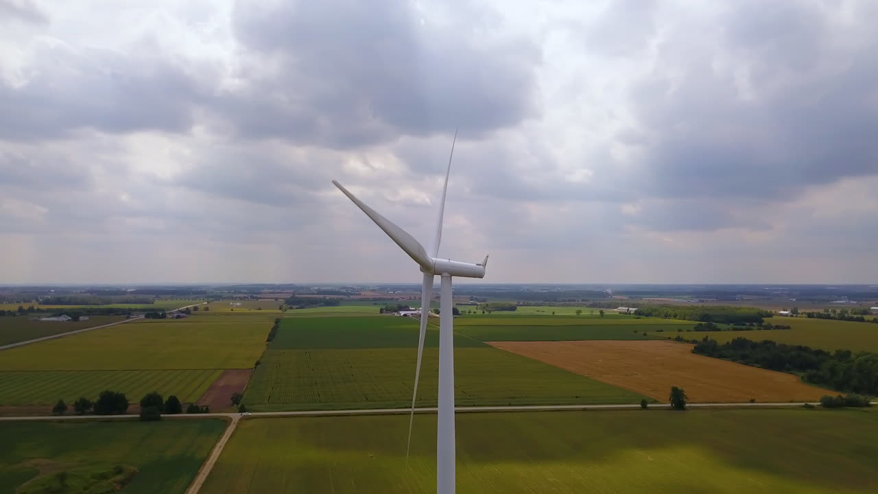 Epic landscape reveal around a wind turbine