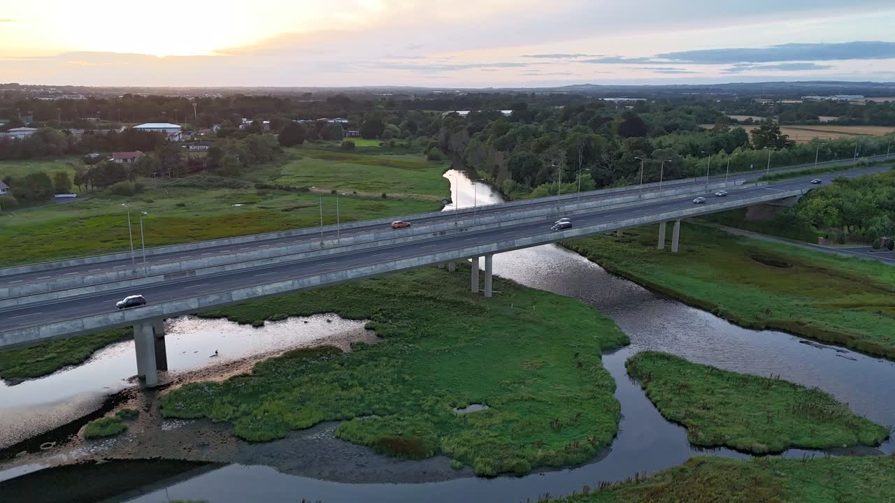 Sunset timelapse contrast between a busy motorway and quiet and calm estuary