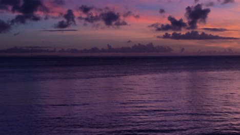 dramatic purple sunset with silhouette of fisherman in lagoon