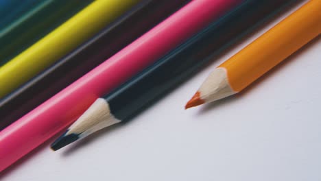 motion-along-row-of-colored-pencils-on-white-background