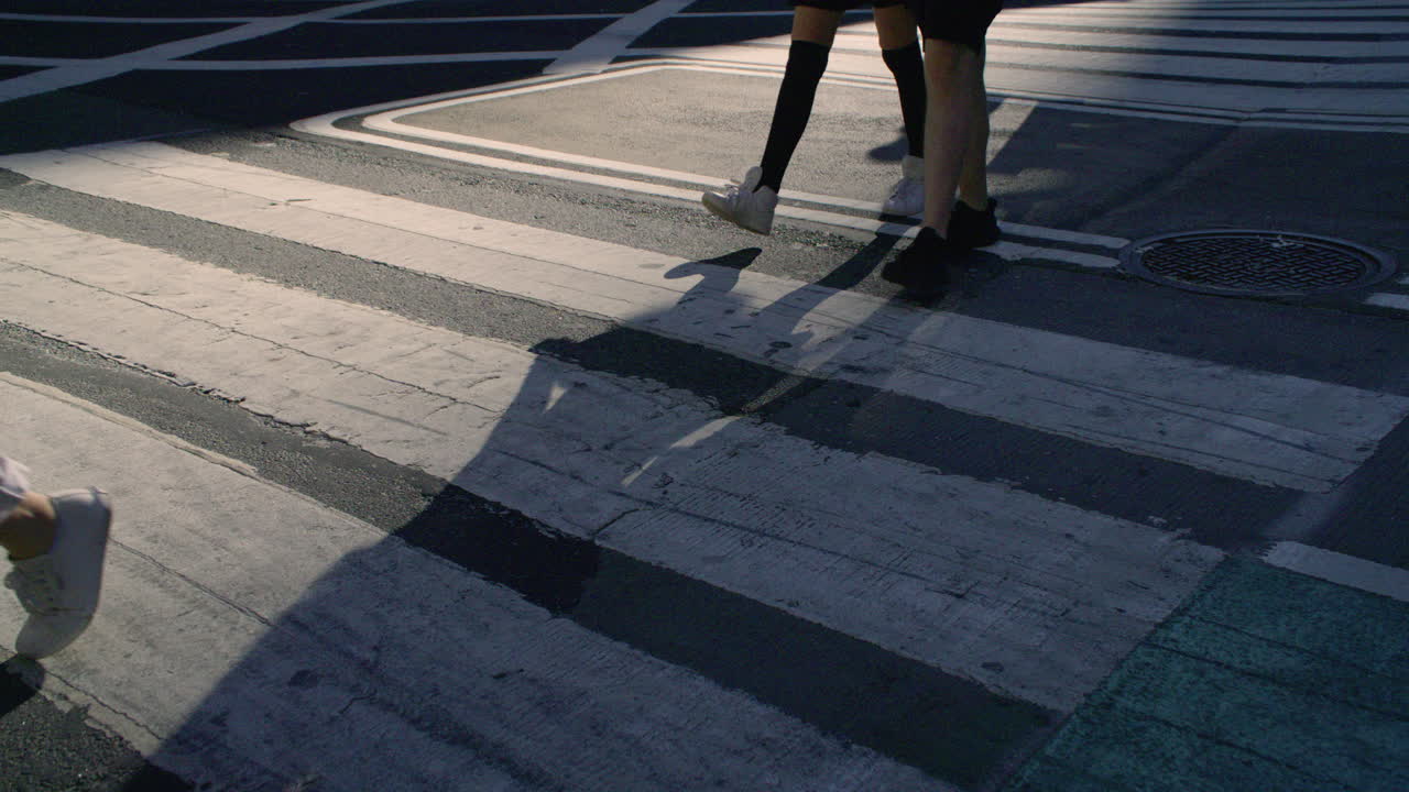 Close-up shot of a New York City crosswalk at sunrise