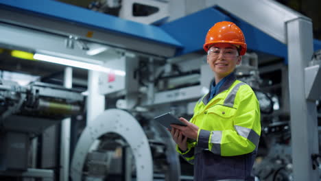 Supervisor-working-tablet-industrial-pant.-Woman-engineer-smiling-modern-factory