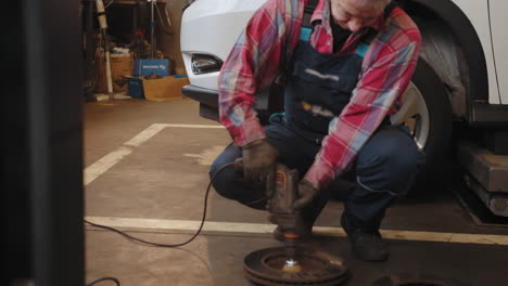 auto mechanic repairing brake discs