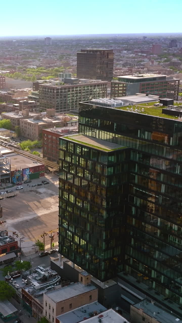Flyover Chicago city panorama. Busy roads among the multi-storied buildings of metropolis. Drone footage. Vertical video