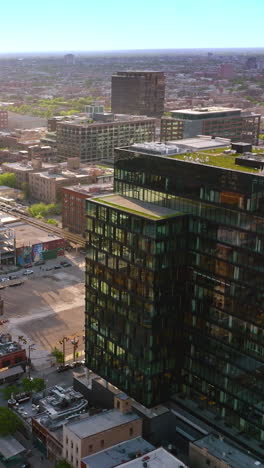 flyover chicago city panorama. busy roads among the multi-storied buildings of metropolis. drone footage. vertical video