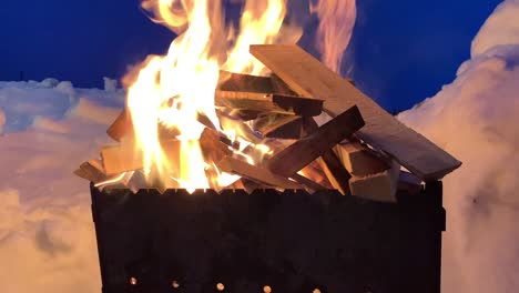 stacked firewood on the grill burns well and brightly at night.