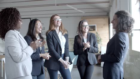 businesswomen applauding to boss in office