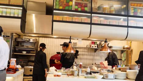 chefs and staff working together in a busy kitchen