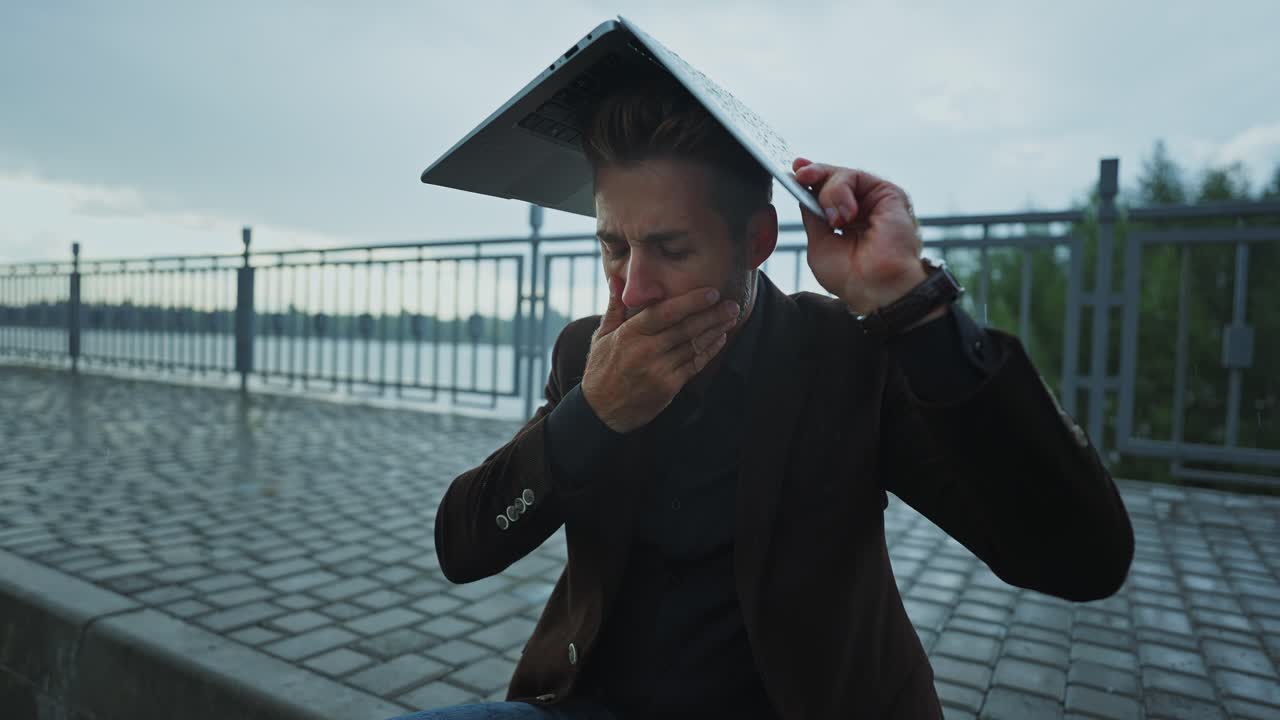 Man with Laptop in the Rain