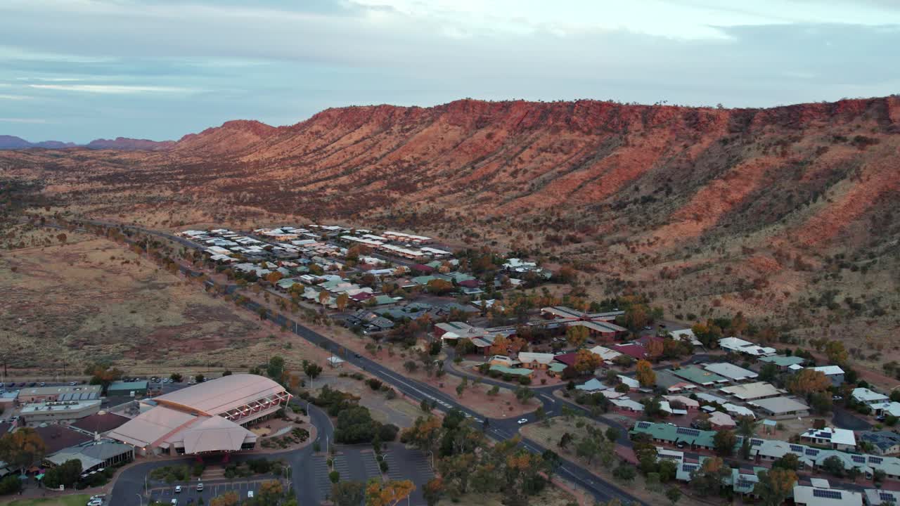 Aerial view of the MacDonnell Ranges near Heavitree Gap, Alice Springs at sunset. Northern Territory, Australia. August 2022.