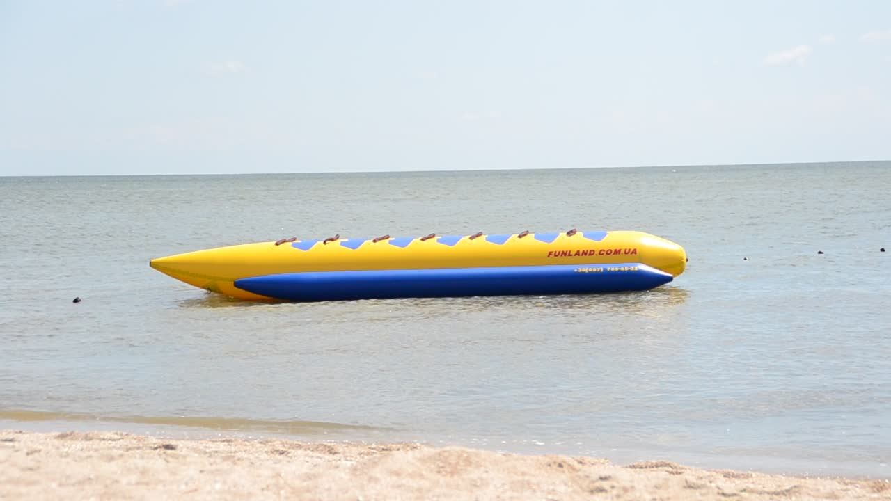 banana boat lays on a beach