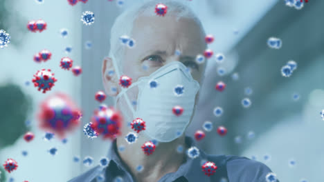 Animation-of-covid-19-virus-cells-over-man-wearing-face-mask