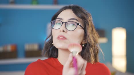 Happy-young-woman-applying-makeup.