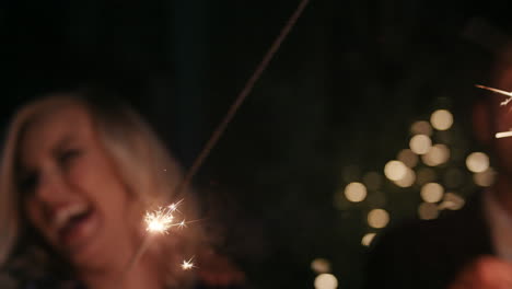 Sexy-group-of-friends-at-glamorous-party-lighting-sparklers