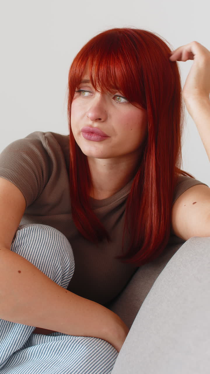 Young woman looks tired and in bad mood after hard news low energy sigh frustrated and drained mood