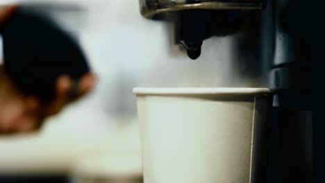 Bartender-preparing-coffee-using-coffee-machine