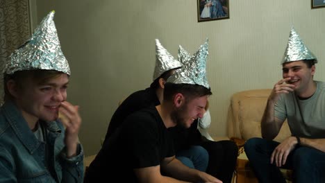 amigos riendo con sombreros de aluminio