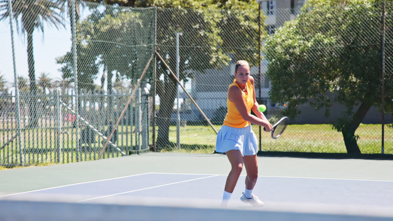 Young Woman Playing Tennis on an Outdoor Court