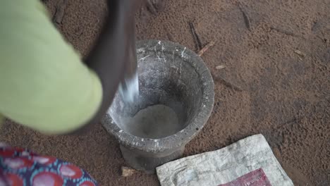 pounding cassava in the mortar. close up