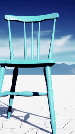 a blue chair in the desert