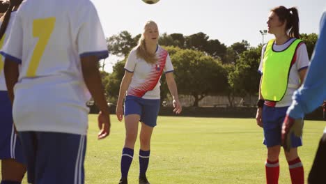 Female-soccer-team-passing-the-ball-on-soccer-field.-4k