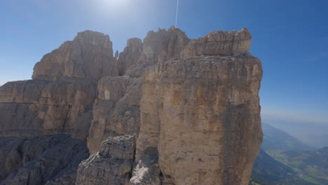 rocky dolomite mountains on sunny day, aerial fpv view