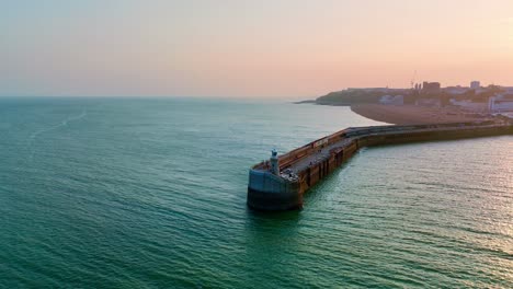 by the sea where the breezes charm, stretches folkestone’s harbour arm