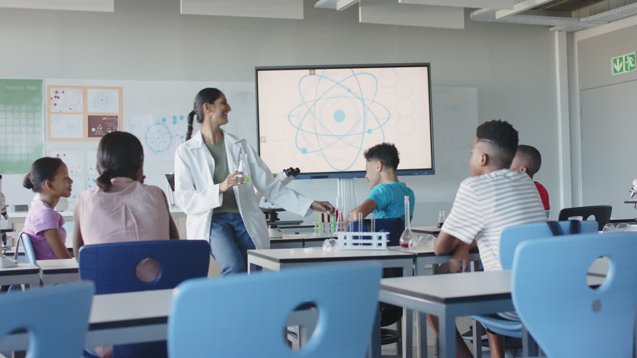 In school, teacher conducting science experiment with students in classroom
