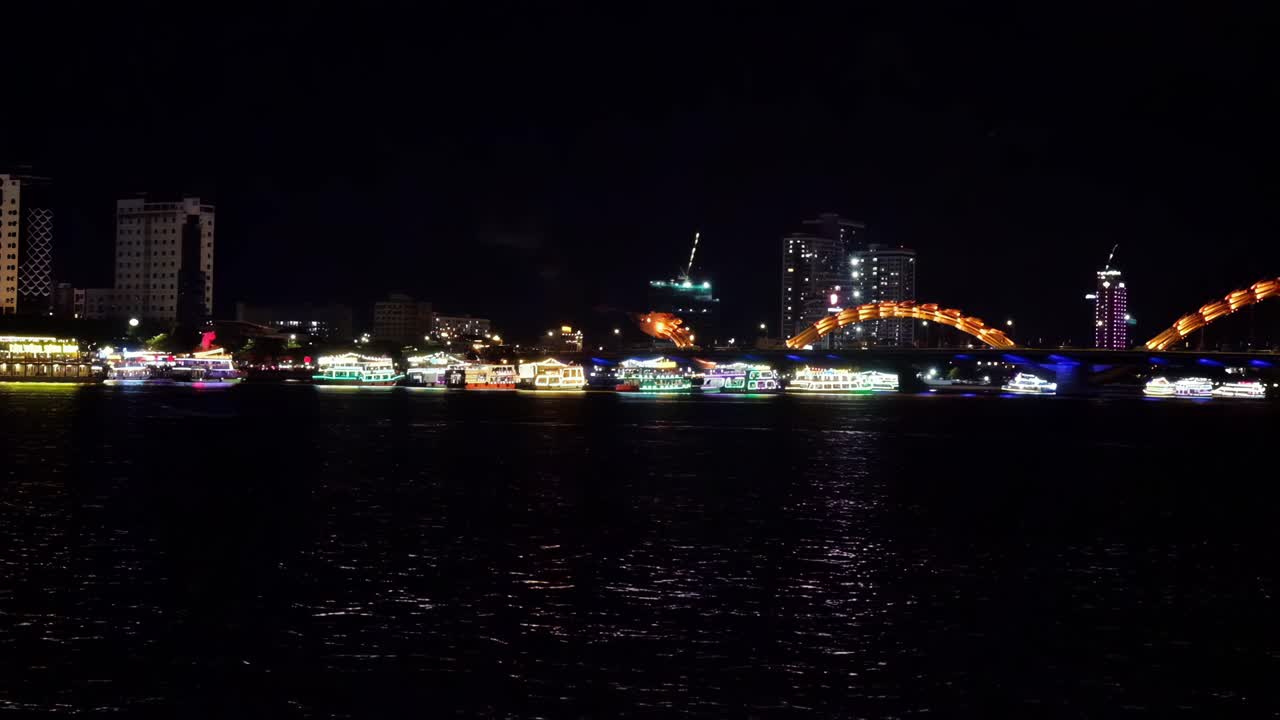 Night View of Illuminated Boats on the Han River with Da Nang Cityscape and Dragon Bridge