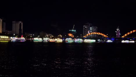 Night View of Illuminated Boats on the Han River with Da Nang Cityscape and Dragon Bridge