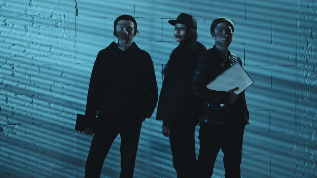 Portrait of Young Hackers in Basement or Hideout