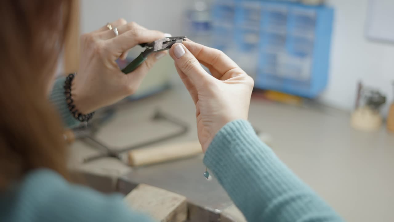 Woman making jewelry in workshop