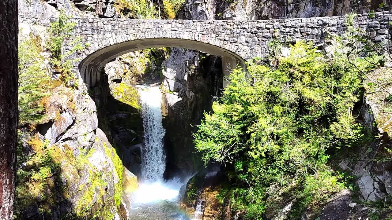 Small Waterfall Flowing under under a stone bridge in North Cascade National Park, USA