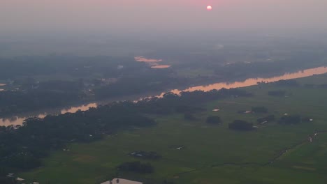 Surma-river-and-agriculture-landscape-of-Bangladesh,-aerial-foggy-view